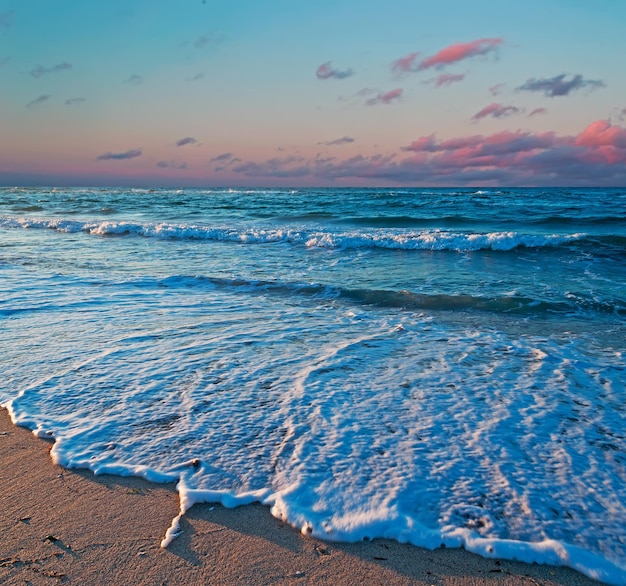 Sea foam on Platamona foreshore at sunset