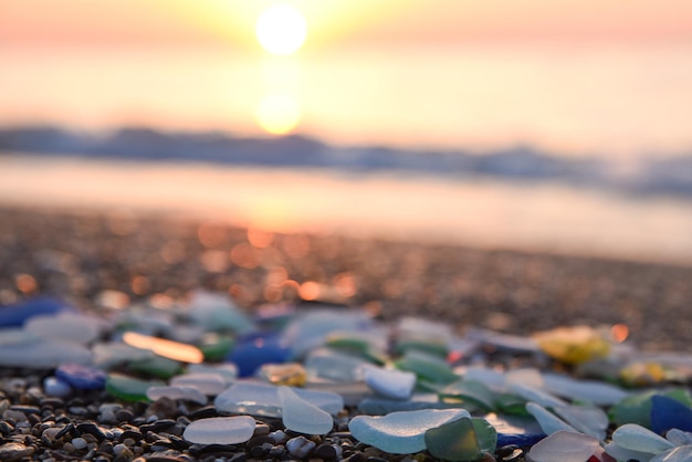 Sea glass Beach polish textured sea glass and stones on seashore Sunset mediterranean sea coast