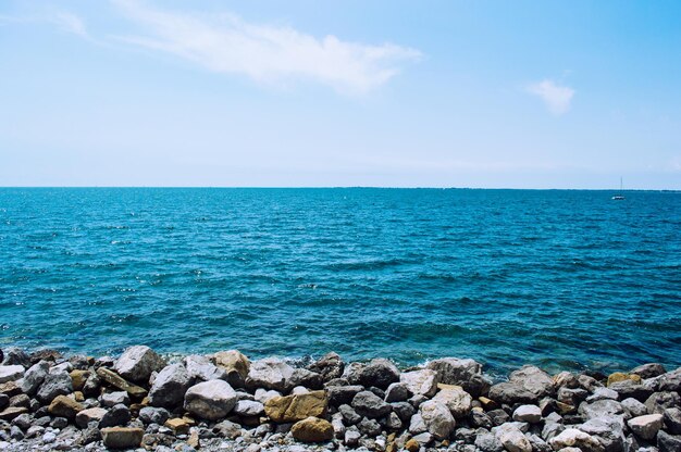 Sea horizon with a coast of stones