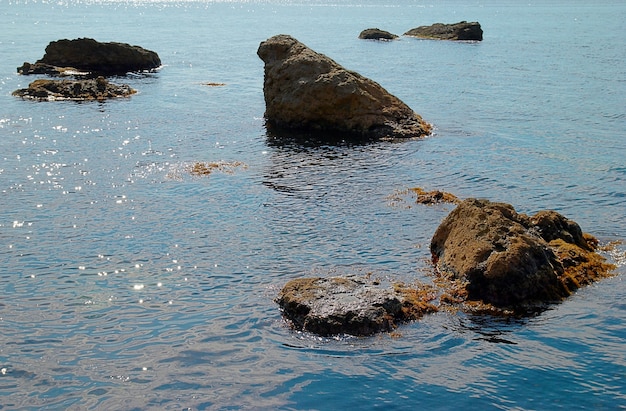 Sea landscape with rocks and water surface.