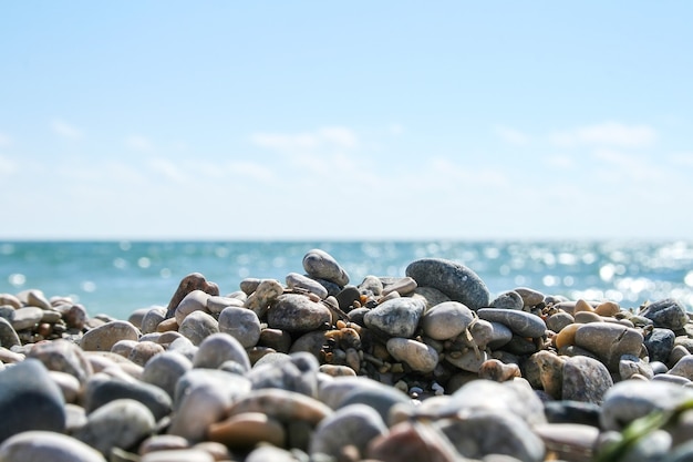 Sea pebbles against a blurred shiny sea