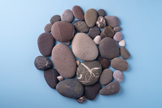 Sea pebbles on blue surface