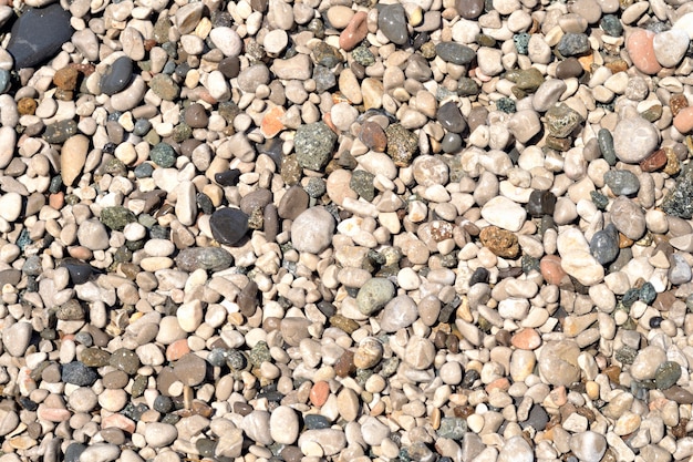 Sea pebbles wet on a sea beach background