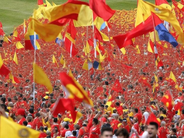 A sea of red and yellow flags wave in the air as the Spanish women's team celebrates their victory