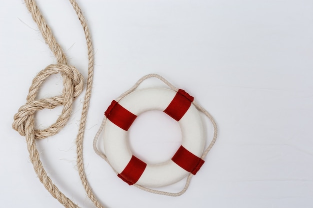 Sea rope knot, lifebuoy and seashells. Top view.