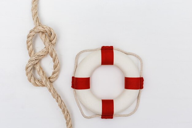 Sea rope knot, lifebuoy on white