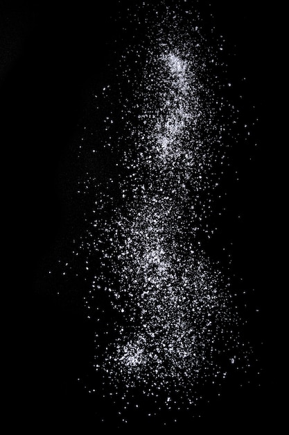 Photo sea salt over black background.