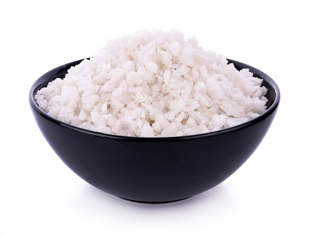 Sea salt in bowl on white background