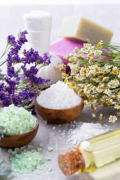 Sea salt in bowl with aroma oil in bottle