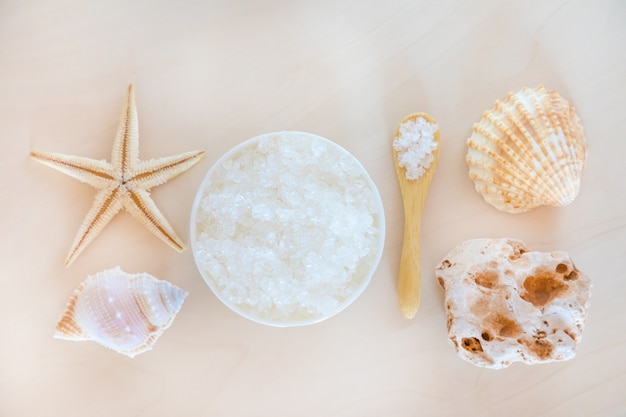 Sea Salt with spoon and starfish on wooden background