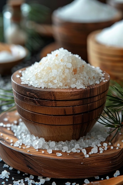 Sea salt in wooden bowl on dark background