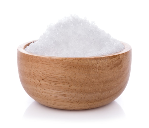 Sea salt on wooden bowl isolated on white background