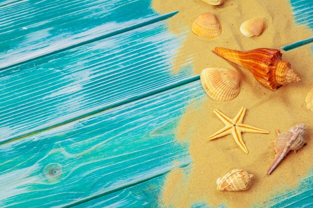 Sea sand and Sea shells on blue wooden floor