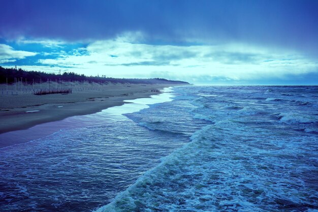 Sea shore in stormy weather Beautiful dramatic sky over beach