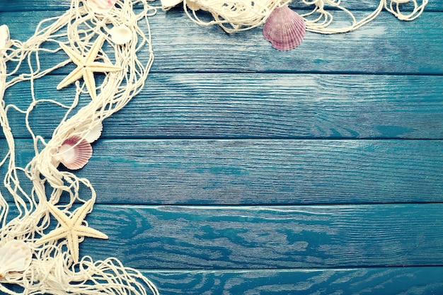 Sea stars and shells on wooden background