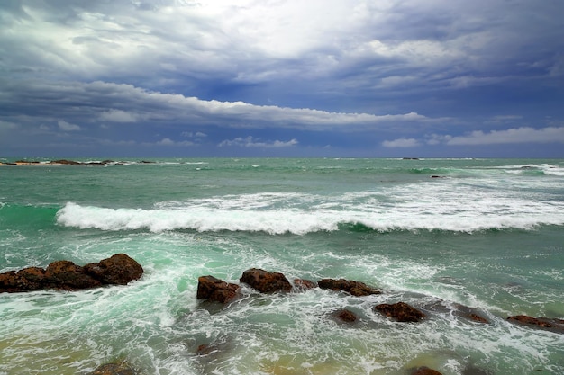 Sea stormy landscape over rocky coastline