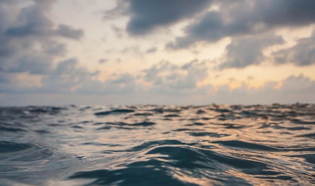 Sea surface, abstract closeup low angle view from swimming person point of view, morning overcast sky background