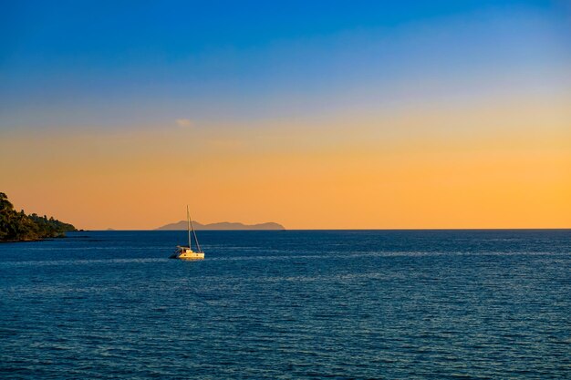 Sea surface and horizon with yacht on beautiful sunset sea view on background