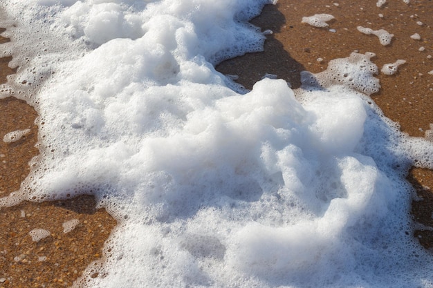Sea thick coastal foam on the sand The phenomenon of coastal cappuccino
