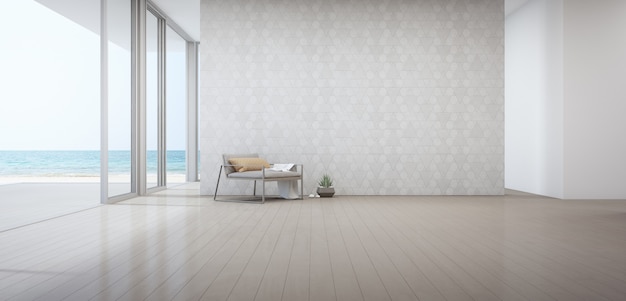 Sea view living room of luxury beach house with armchair near door on wooden floor.