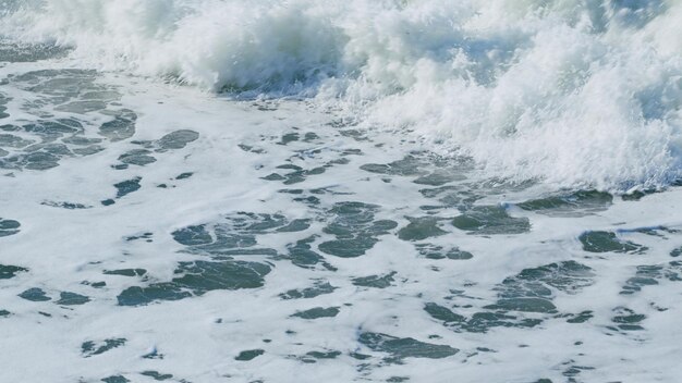 Sea water waves wave after wave swept towards shore slow motion