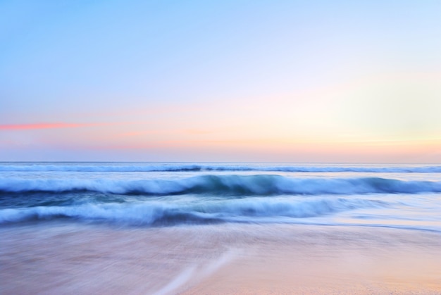 Sea wave on the beach at sunset time