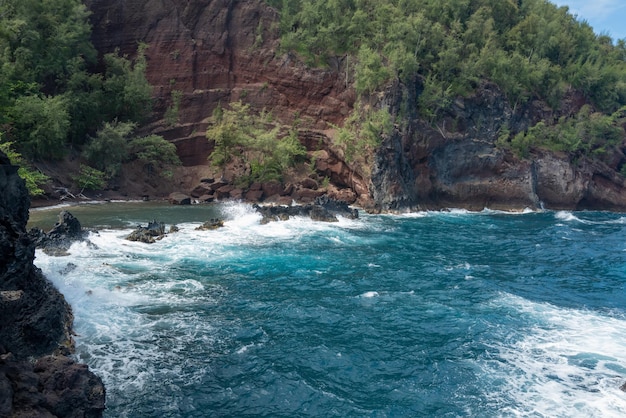 海の波と岩の夏のビーチの背景