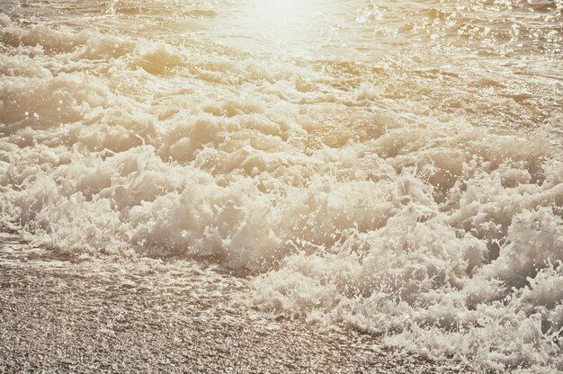 Sea wave splashing to the coast natural vintage sunny background