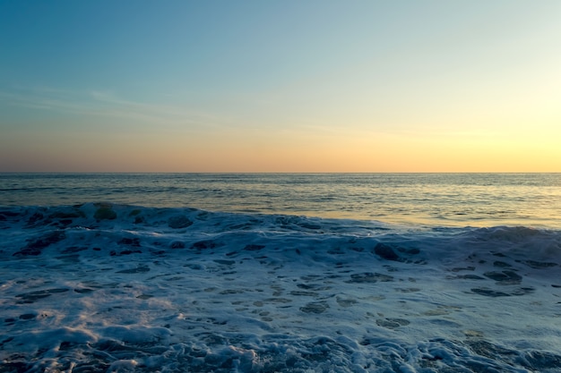 Sea waves breaking on a stony beach