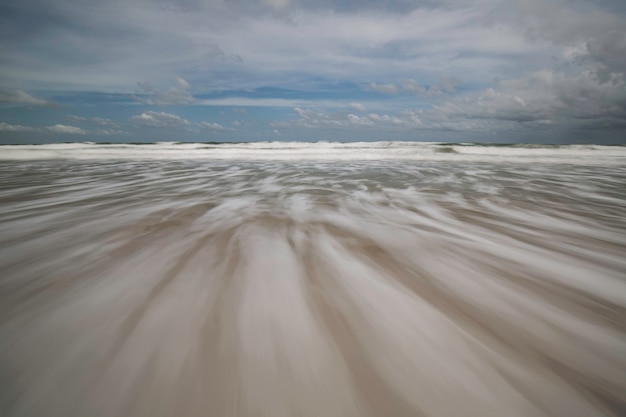 Sea waves lash line motion on the beach