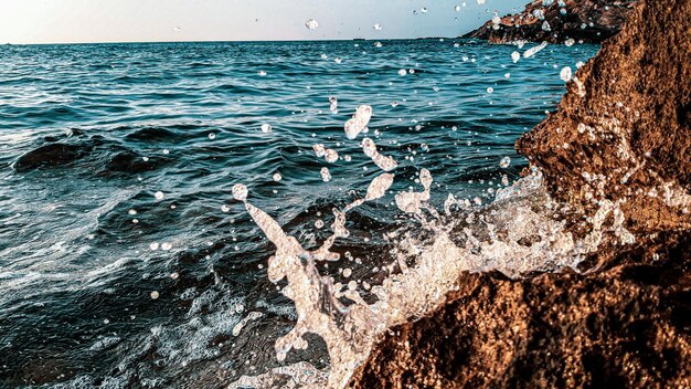 Photo sea waves splashing on rocks