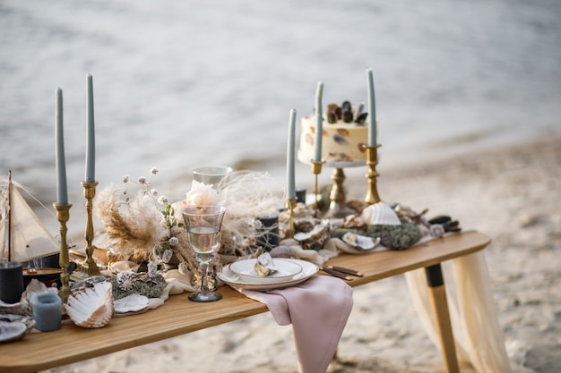 海岸の海の結婚式の装飾。イベントでのウェディングケーキと花。