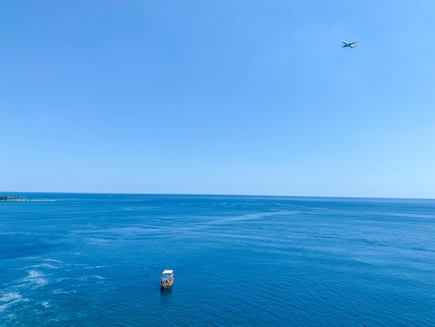 Sea with blue water boat in the center a boat with tourists floats on the water rest on the sea