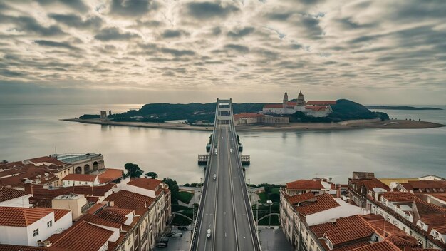 Photo sea with a bridge on it surrounded by the coimbra city under a cloudy sky in portugal