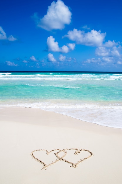 Sea with hearts written in the sand