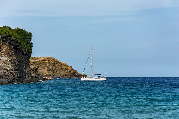 Sea yacht in the parking lot at the rocky coast