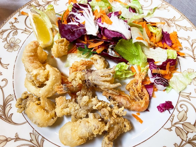 Seafood in batter on plate close up in restaurant