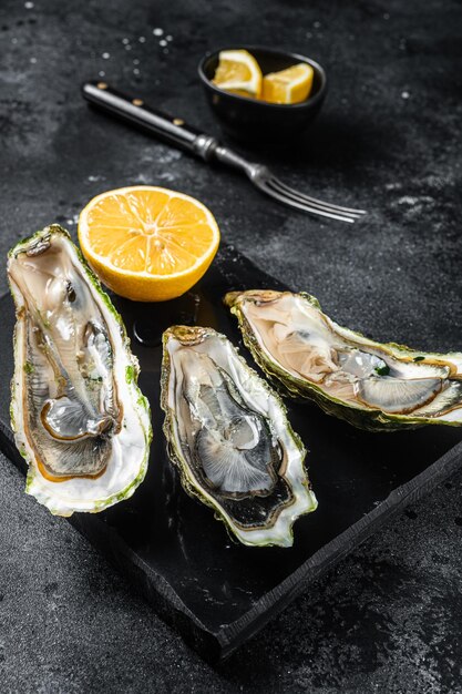 Seafood Brassiere open Oysters with lemon Black background Top view