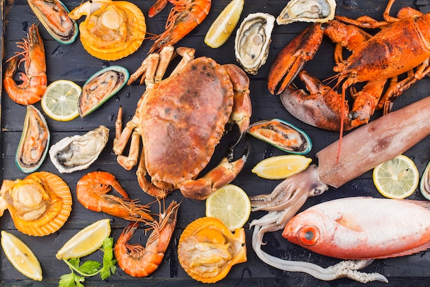 Seafood dinner, seafood dinner with fresh lobster, crab, mussel and oyster as background