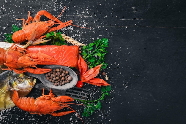 Seafood Fish Vomer lobster salmon On a wooden background Top view Free space for text