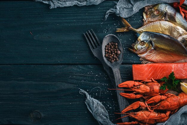 Seafood Fish Vomer lobster salmon On a wooden background Top view Free space for text