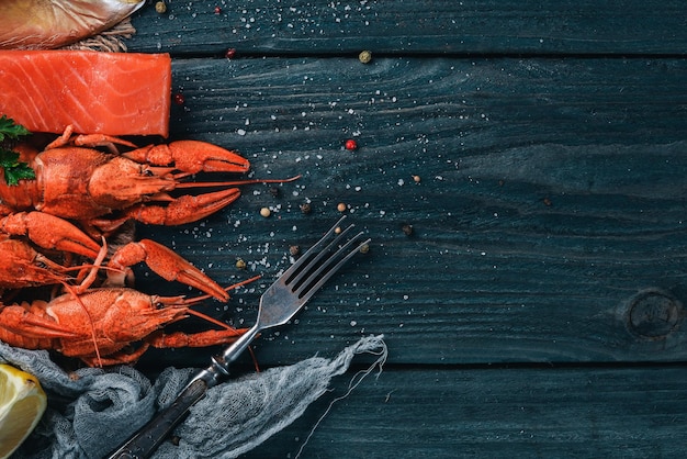 Seafood Fish Vomer lobster salmon On a wooden background Top view Free space for text