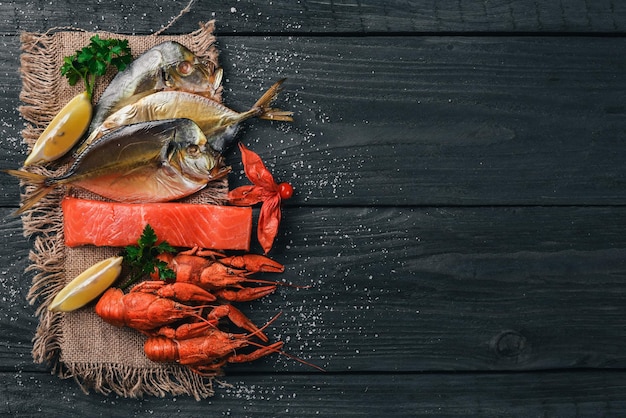 Seafood Fish Vomer lobster salmon On a wooden background Top view Free space for text