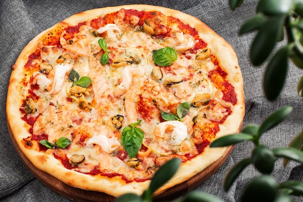 Seafood Italian pizza with shrimp,squid, mussels, fresh herbs and mozzarella