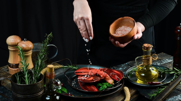 Seafood Lobster claws on a plate in the hands of the chef Food banner