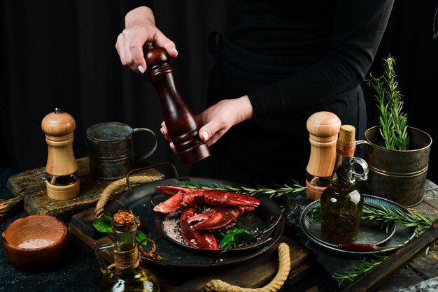 Seafood Lobster claws on a plate in the hands of the chef Food banner