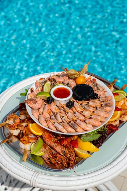 Seafood at a luxury resort overlooking the pool shrimp lobster crabs fruit crane sauce