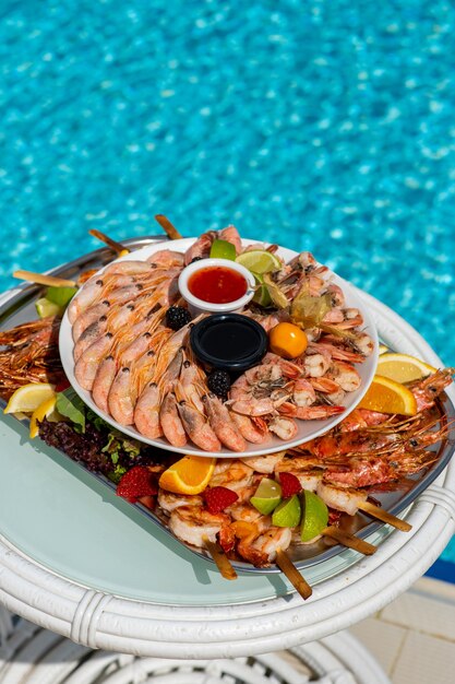 Seafood at a luxury resort overlooking the pool shrimp lobster crabs fruit crane sauce