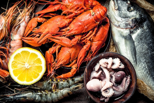 Seafood in an old tray. On a wooden background.