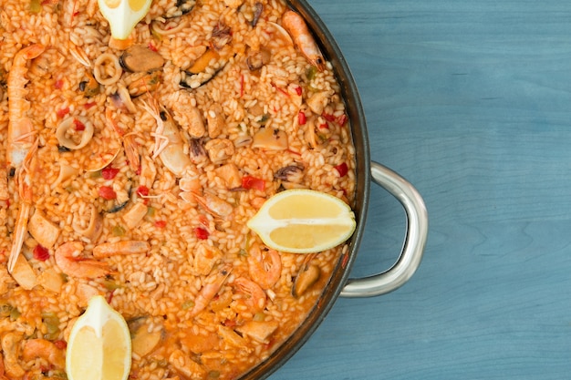 Seafood paella on a wooden blue background